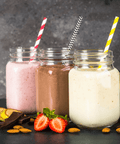 High Quality Honeycomb Milkshake Toppings in jars with colorful straws, surrounded by fresh fruits and chocolate.